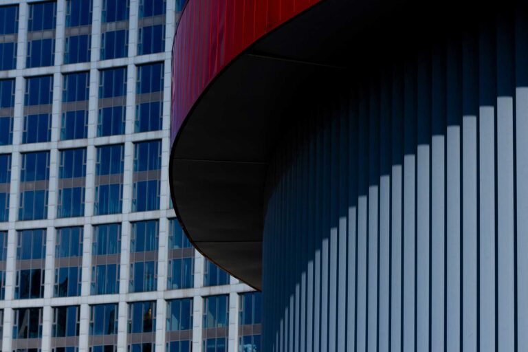 Architectural metal facade formed from precision-machined aluminum extrusions