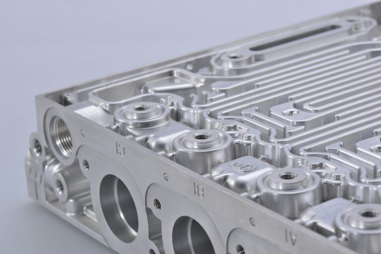 Precision-machined aluminum automotive component produced from extruded stock